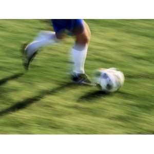  Low Section View of a Soccer Player Running with the Ball 