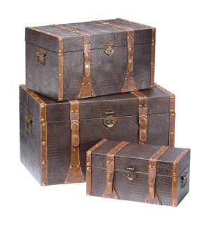 This set ofthree trunks have a tobacco finish and bass colored hinges 