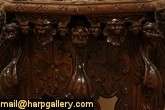   chairside table or pedestal has deeply sculpted gargoyles lion