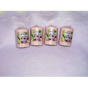   Four Enchanted Orchid Scented Candles Sold As a Set.